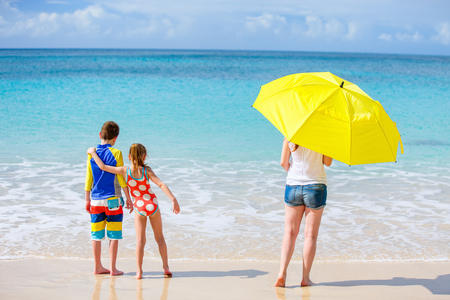 Family mother and kids enjoying tropical beach vacationの写真素材