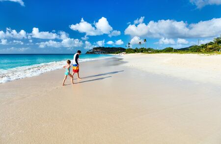 Father and his adorable little daughter at beachの写真素材
