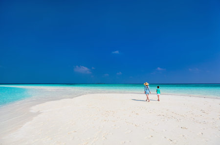 Mother and daughter enjoying tropical beach vacationの写真素材