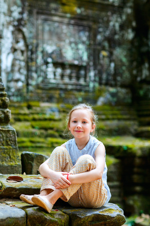 Little girl in ancient Angkor Wat temple in Siem Reap, Cambodiaの写真素材