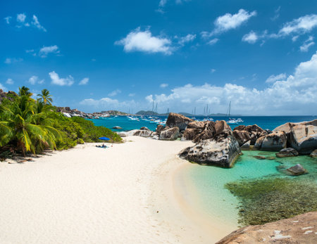 Stunning beach with white sand, unique huge granite boulders, turquoise ocean water and blue sky at...
