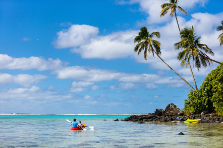 Father and daughter kayaking at tropical oceanの写真素材