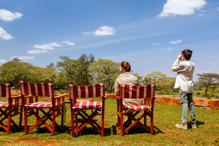 Family of mother and child on African safari vacation enjoying wildlife viewingの写真素材
