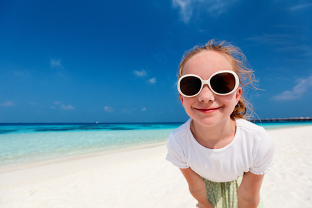 Adorable little girl at beach during summer vacationの写真素材