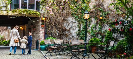 Panorama of mother and her kids outdoors in European cityの写真素材