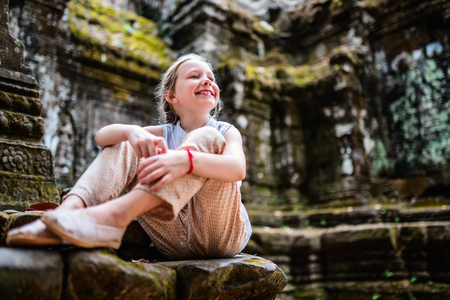Little girl in ancient Angkor Wat temple in Siem Reap, Cambodiaの写真素材