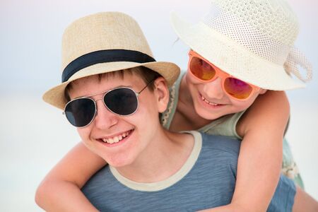 Portrait of kids having fun during tropical summer vacation playing outdoors togetherの写真素材