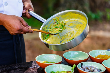 Chef making traditional Sri Lankan curry dish at cooking classの写真素材