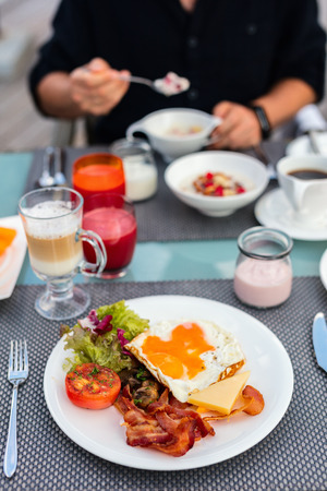Delicious breakfast with fried eggs, bacon and vegetablesの写真素材