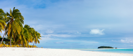 Panorama of stunning tropical Aitutaki One Foot island with palm trees, white sand, turquoise ocean water and blue sky at Cook Islands, South Pacificの写真素材