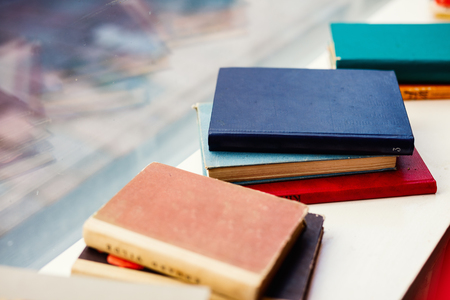 Close up details of old books with colorful covers at flea marketの写真素材