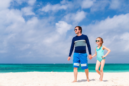 Father and his adorable little daughter at beachの写真素材