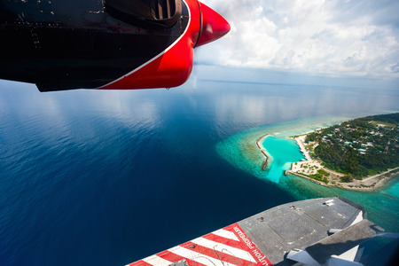 Aerial view of Maldives tropical island seen from a sea planeの写真素材