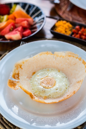Traditional Sri Lankan breakfast with egg hoppersの写真素材