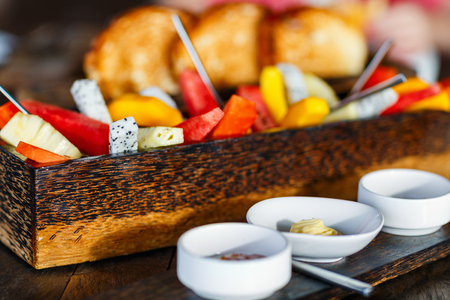 Close up of delicious organic food served for breakfast on rustic wooden table. Fruits, juice, croissants and jam flat lay.の写真素材