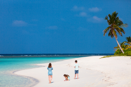 Family mother and kids enjoying tropical beach vacationの写真素材