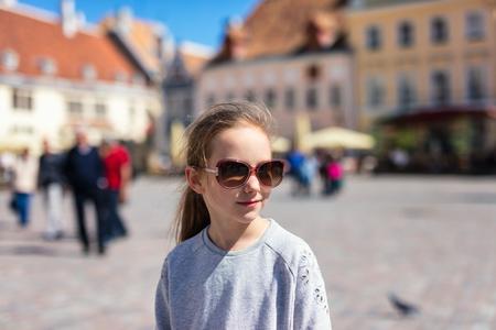 Casual portrait of little girl outdoors in Tallinn old town on summer dayの写真素材