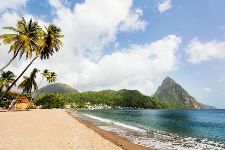 Idyllic white sand tropical beach with view to Piton mountains in Saint Lucia Caribbean