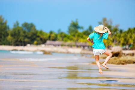 Adorable little girl having fun at Ngapali beach in Myanmar during summer vacationの写真素材