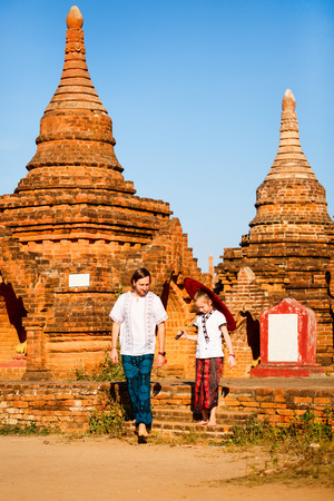 Family of father and daughter visiting ancient temples in Bagan Archeological area in Myanmarの写真素材