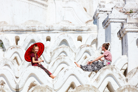 Kids brother and sister at beautiful white Hsinbyume pagoda in Mingun Myanmarの写真素材