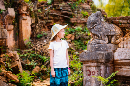 Young girl visiting Shwe Indein pagoda near lake Inle in Myanmarの写真素材