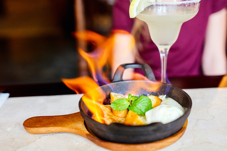 Banana flambe with rum and aged honey served over pancakes and vanilla ice creamの写真素材