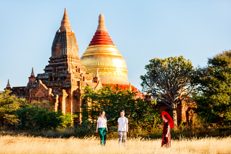 Family of mother and kids visiting Dhammayazika Pagoda and ancient temples in Bagan Archeological area in Myanmarの写真素材
