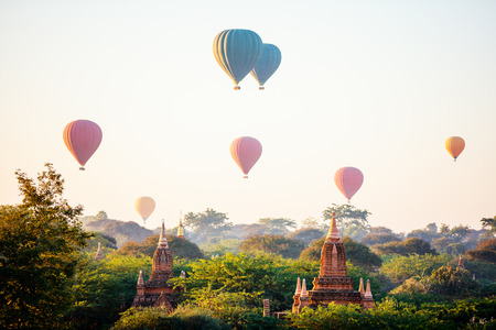 Stunning landscape view of hot air balloons fly over thousands of ancient pagodas at morning in Bagan Myanmarの写真素材