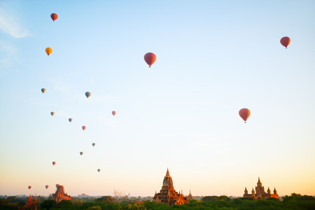 Stunning landscape view of hot air balloons fly over thousands of ancient pagodas at morning in Bagan Myanmarの写真素材