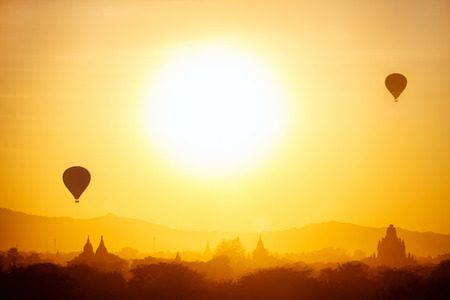 Stunning sunrise view of hot air balloons fly over thousands of ancient pagodas at morning in Bagan Myanmarの写真素材