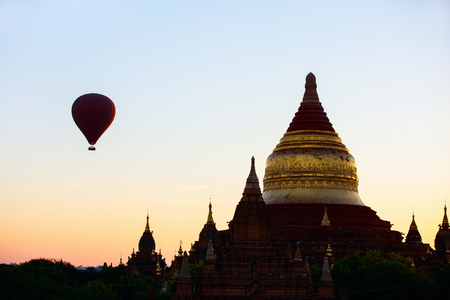 Stunning sunrise view of hot air balloons fly over  Dhammayazika Pagoda historic buddhist temple in Bagan Myanmarの写真素材