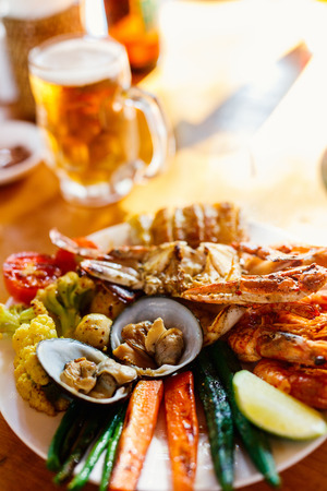 Close up of delicious grilled vegetables and seafoodの写真素材