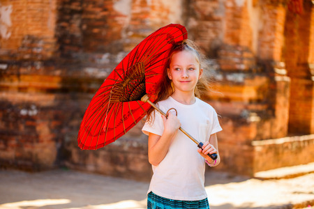 Young girl with traditional burmese parasol outdoorsの写真素材