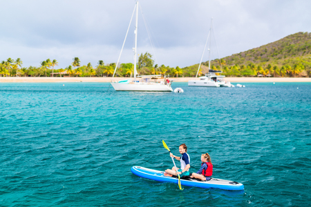 Father and daughter kayaking at tropical oceanの写真素材