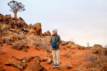 Young girl outdoor at Namib desert on cold winter evening