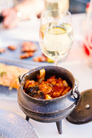 Seafood in rich tomato sauce served in a potの写真素材