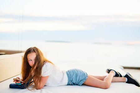 Casual portrait of teenage girl outdoors on summer dayの写真素材