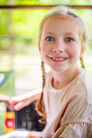 Casual portrait of little girl outdoors on summer dayの写真素材