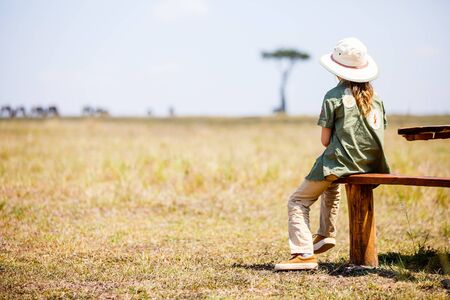 Adorable little girl enjoying safari vacation in Kenyaの写真素材