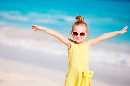 Adorable little girl at tropical white sand beachの写真素材