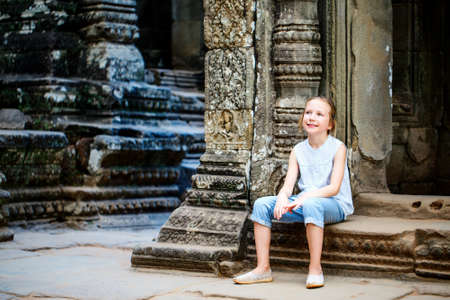 Little girl in ancient Angkor Wat temple in Siem Reap, Cambodiaの写真素材