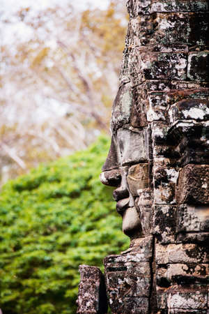Faces of ancient Bayon temple popular tourist attraction in Angkor Thom, Siem Reap, Cambodiaの写真素材