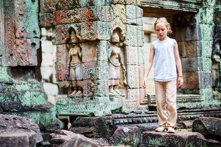Little girl in ancient Angkor Wat temple in Siem Reap, Cambodiaの写真素材