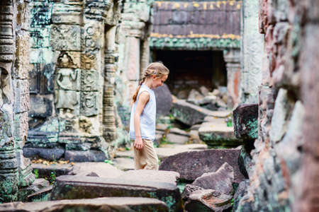 Little girl in ancient Angkor Wat temple in Siem Reap, Cambodiaの写真素材