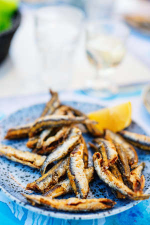 Close up of delicious grilled fish served for lunch with white wineの写真素材