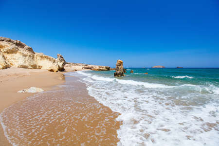 Idyllic beach surrounded by beautiful cliffs on Greek island of Milosの写真素材