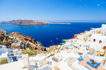 Breathtaking view of Oia village with traditional white architecture and blue-domed churches on Santorini island in Greeceの写真素材