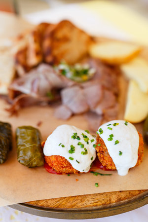 Selection of traditional greek meze: fava, greek salad, stuffed grape leaves and olives