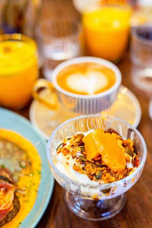 Delicious breakfast with tropical fruits, granola and fresh yoghurt